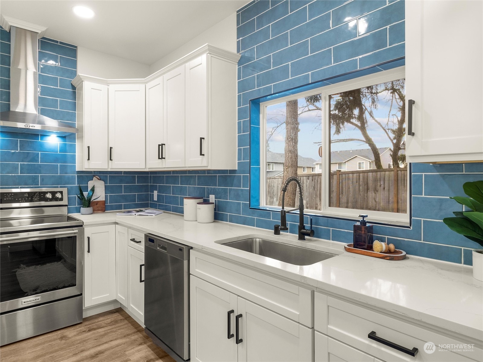 9331 Cullens Road Southeast Yelm, WA 98597 - Photo 8 of 28 a kitchen with stainless steel appliances white cabinets and a sink