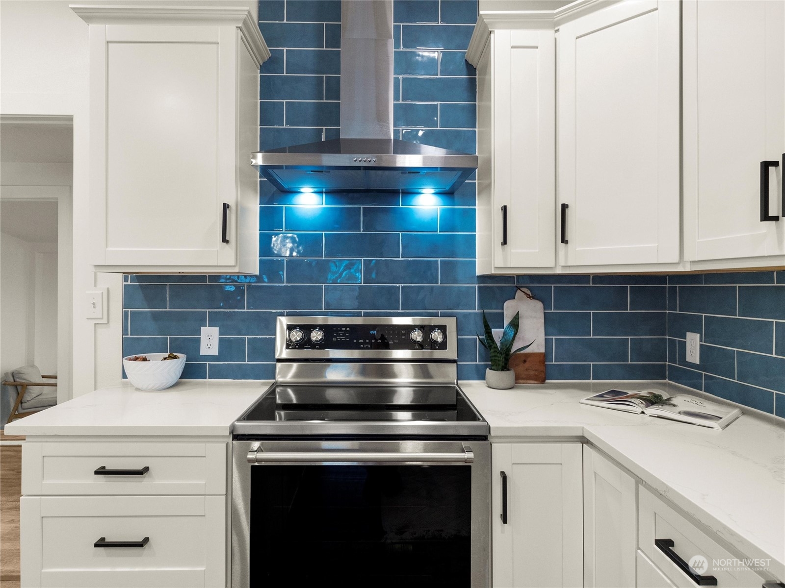 9331 Cullens Road Southeast Yelm, WA 98597 - Photo 10 of 28 a kitchen with a stove and white cabinets