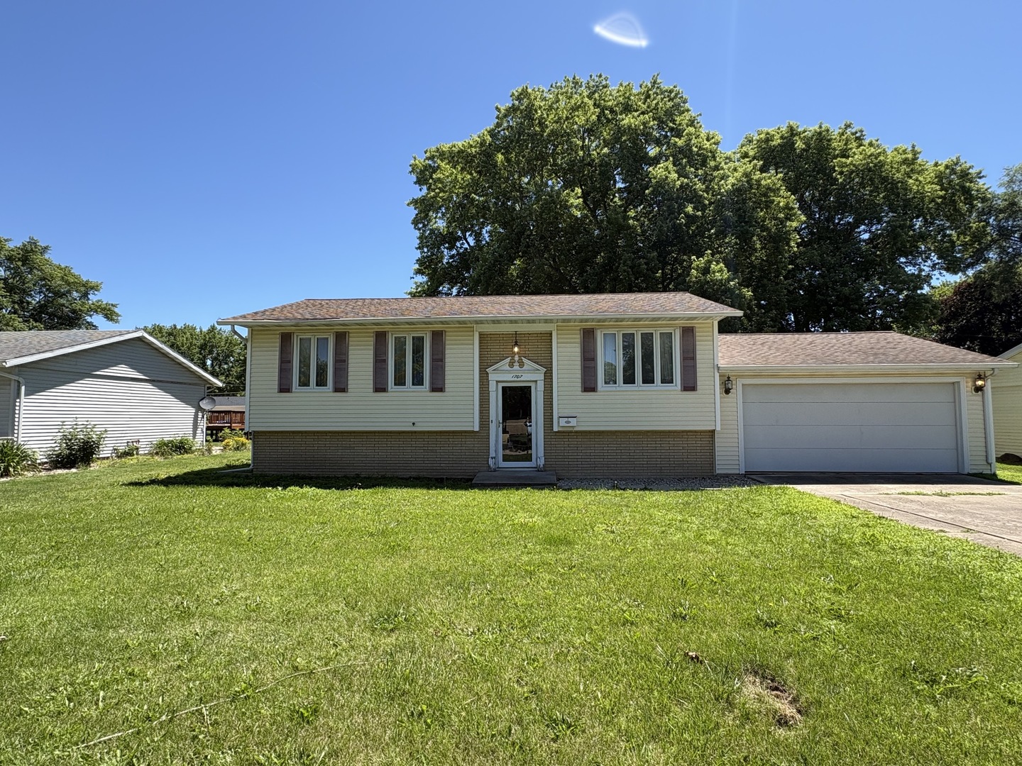 a view of a house with a yard and sitting area