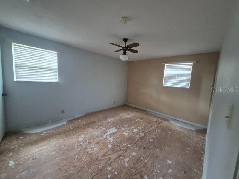 1702 Ketch Place Brandon, FL 33511 - Photo 6 of 14 an empty room with windows and ceiling fan