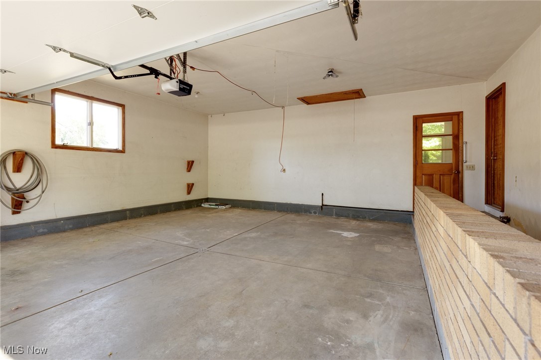 3433 Greenwich Road Barberton, OH 44203 - Photo 28 of 41 Double car garage also has a separate entrance to the sunroom, kitchen and basement at the foot of the stairs, which are hidden by the half wall in this photo.