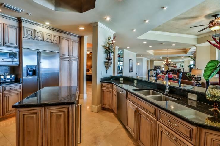 50 Surf Song Lane, Unit E514 Miramar Beach, FL 32550 - Photo 13 of 28 a kitchen with stainless steel appliances granite countertop a sink and a refrigerator