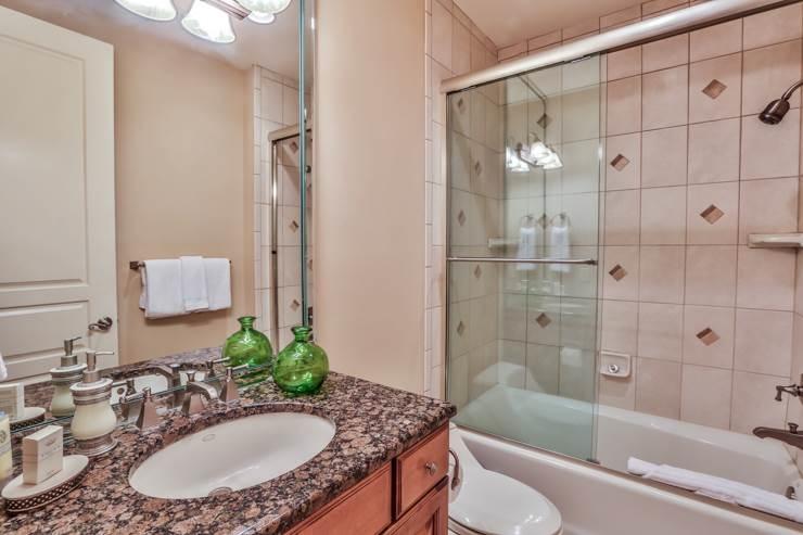 50 Surf Song Lane, Unit E514 Miramar Beach, FL 32550 - Photo 18 of 28 a bathroom with a granite countertop sink and a mirror a bathtub
