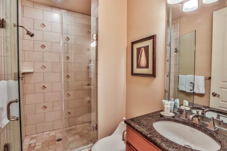 50 Surf Song Lane, Unit E514 Miramar Beach, FL 32550 - Photo 21 of 28 a bathroom with a granite countertop sink a toilet and shower