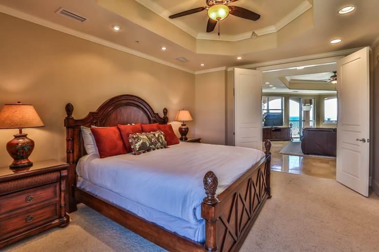 50 Surf Song Lane, Unit E514 Miramar Beach, FL 32550 - Photo 23 of 28 a bedroom with a bed and chandelier