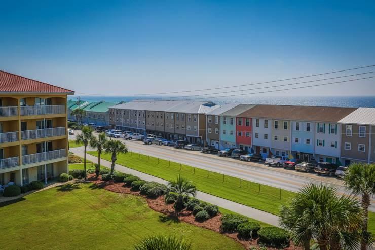 50 Surf Song Lane, Unit E514 Miramar Beach, FL 32550 - Photo 25 of 28 a swimming pool with outdoor seating and yard