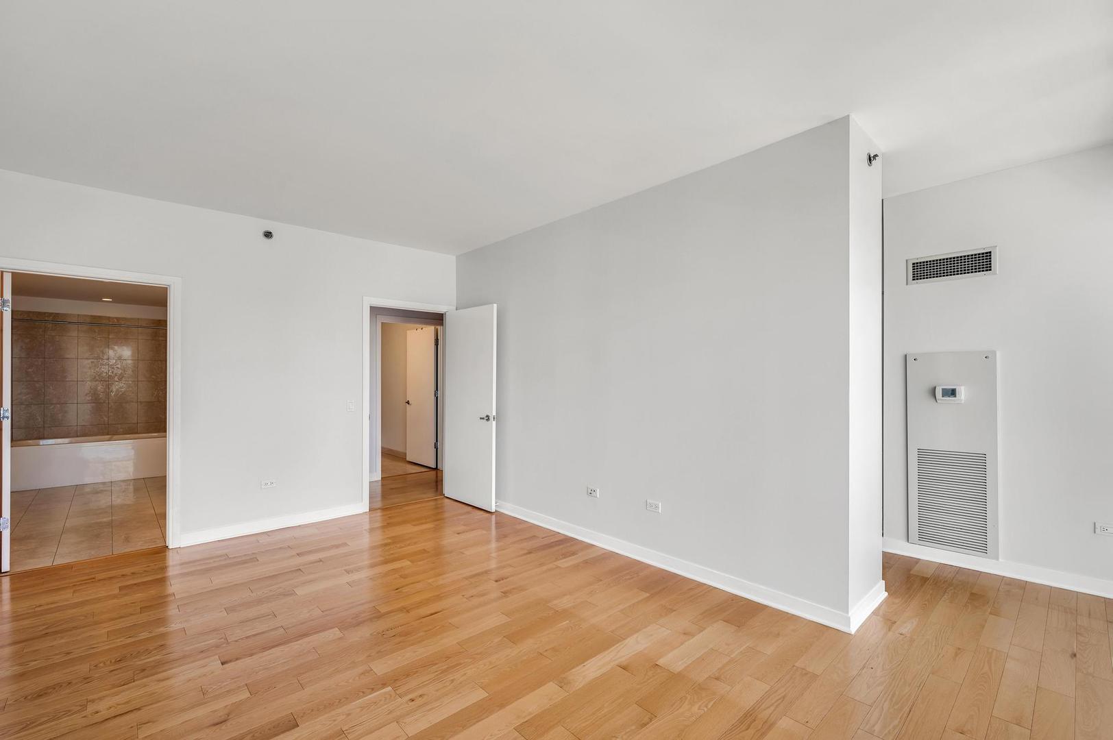 8 East Randolph Street, Unit 3108 Chicago, IL 60601 - Photo 11 of 17 a view of an empty room with wooden floor and closet