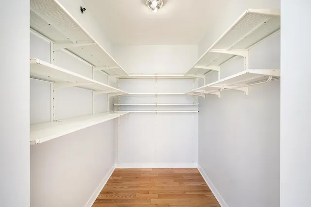 a view of walk in closet with empty racks