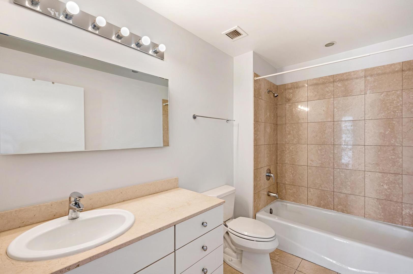 8 East Randolph Street, Unit 3108 Chicago, IL 60601 - Photo 14 of 17 a bathroom with a sink a toilet and a mirror