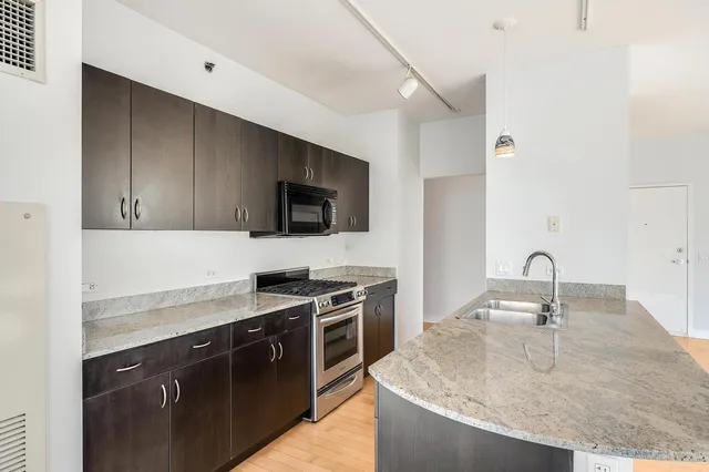 a kitchen with a sink a stove and microwave
