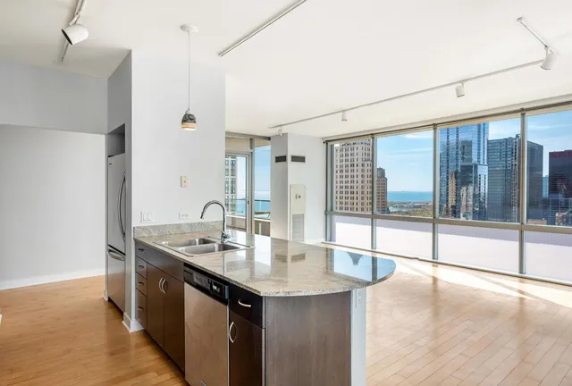 a kitchen with kitchen island a sink and wooden floor