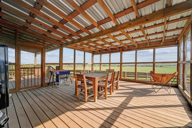 a view of a green field with lots of trees