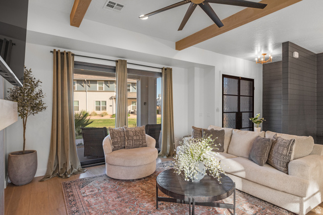 5367 Cyan Lane St. George, UT 84790 - Photo 30 of 49 Living area featuring wood-finish flooring, a contemporary ceiling fan, exposed wood beams, a dark shiplap accent wall, and a black framed glass door