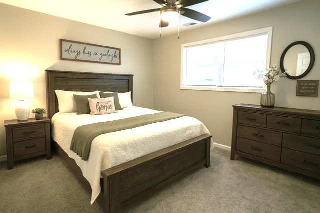 a bedroom with a bed and a window