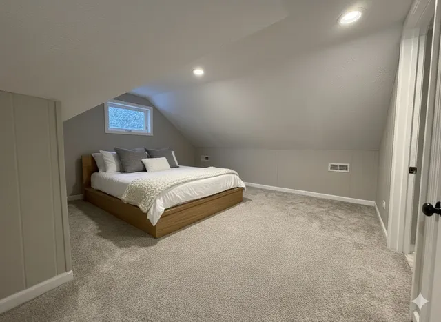 a bedroom with a bed and a lamp