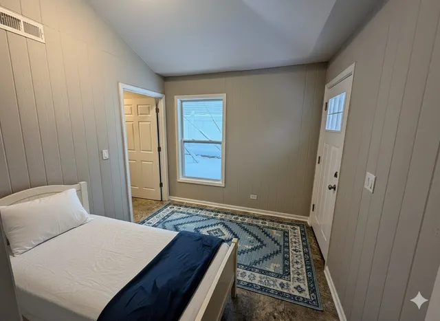 a bedroom with a bed and a window