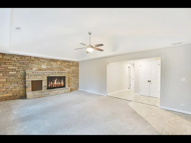 a view of an empty room with a fireplace