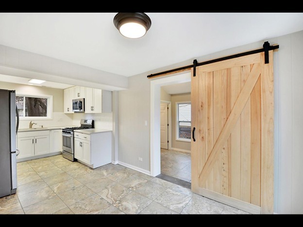 23519 North Field Road Lake Zurich, IL 60047 - Photo 4 of 14 a view of a kitchen with a sink and dishwasher a refrigerator with wooden floor