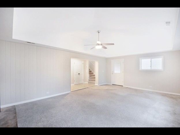 23519 North Field Road Lake Zurich, IL 60047 - Photo 8 of 14 a view of an empty room with chandelier fan and window