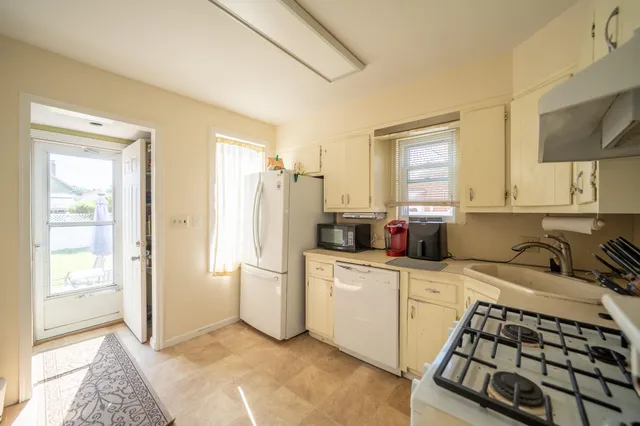 a kitchen with a refrigerator and a sink