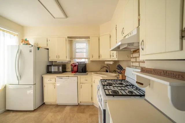 a kitchen with a white stove top oven and refrigerator