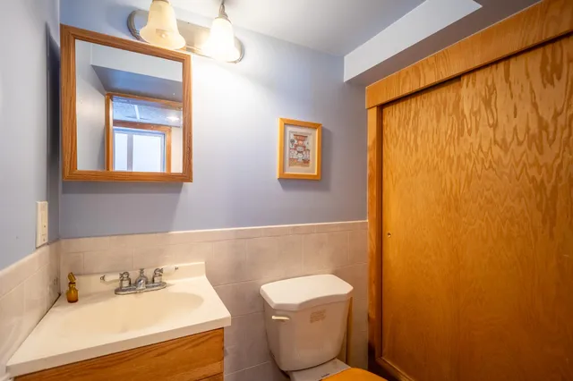 a bathroom with a toilet sink and mirror