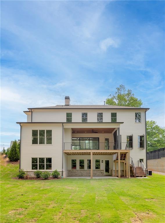 10908 Woodstock Road Roswell, GA 30075 - Photo 26 of 26 a large building with a big yard and potted plants