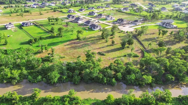 an aerial view of residential houses with outdoor space and swimming pool