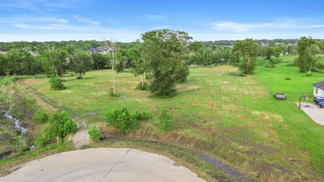 a view of a big yard with large trees