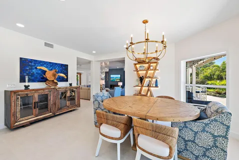 a view of a dining room with furniture a chandelier and wooden floor