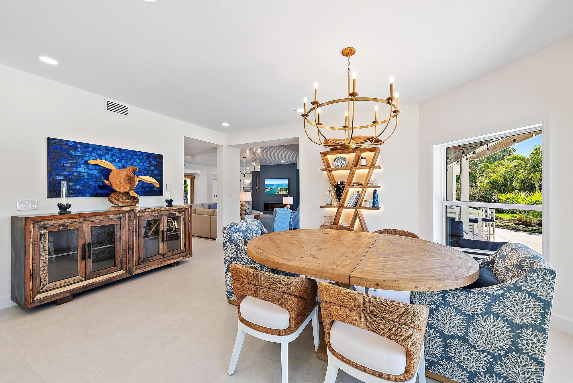 19 Island Road Sewall's Point, FL 34996 - Photo 17 of 50 a view of a dining room with furniture a chandelier and wooden floor