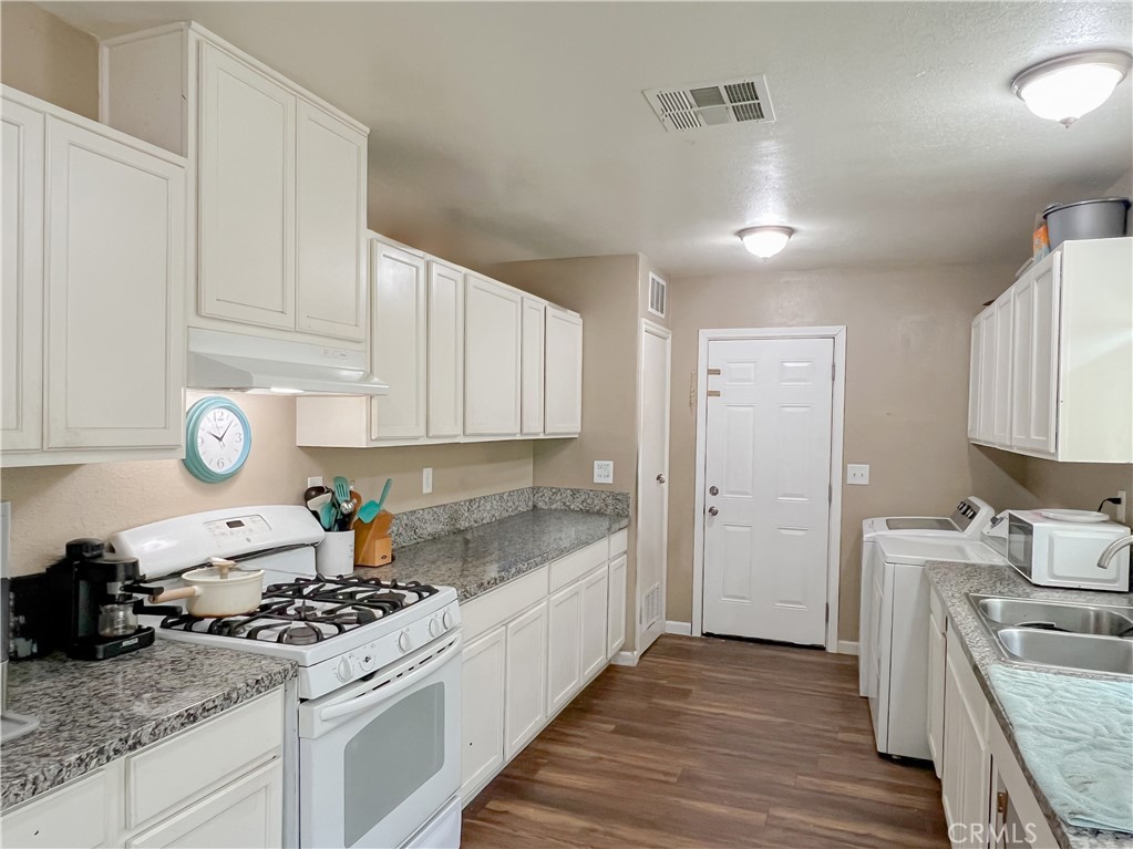 3013 Cornell Street Bakersfield, CA 93305 - Photo 6 of 20 a kitchen with granite countertop a stove and a sink