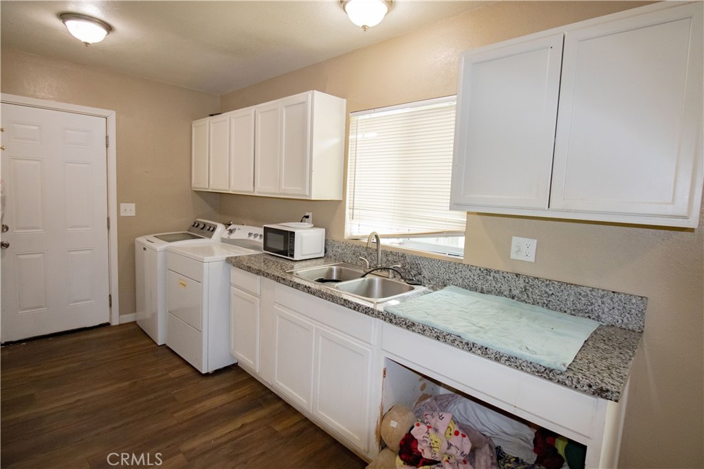 3013 Cornell Street Bakersfield, CA 93305 - Photo 8 of 20 a kitchen with a sink window and cabinets