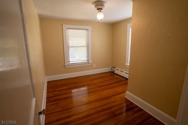 a view of room with window and hardwood floor