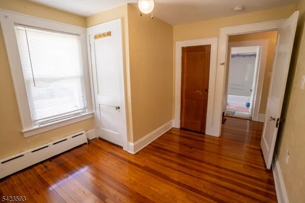 a view of a room with wooden floor and window