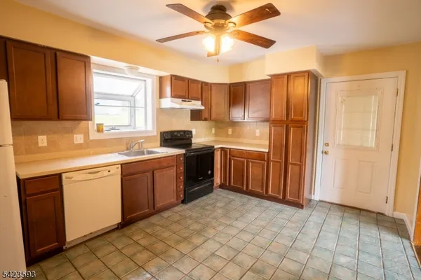 a kitchen with a sink window and cabinets