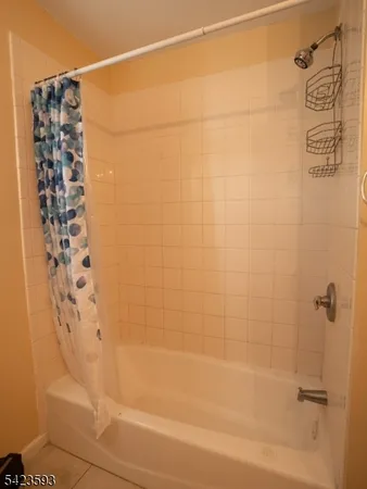 a bathroom with a bathtub and shower