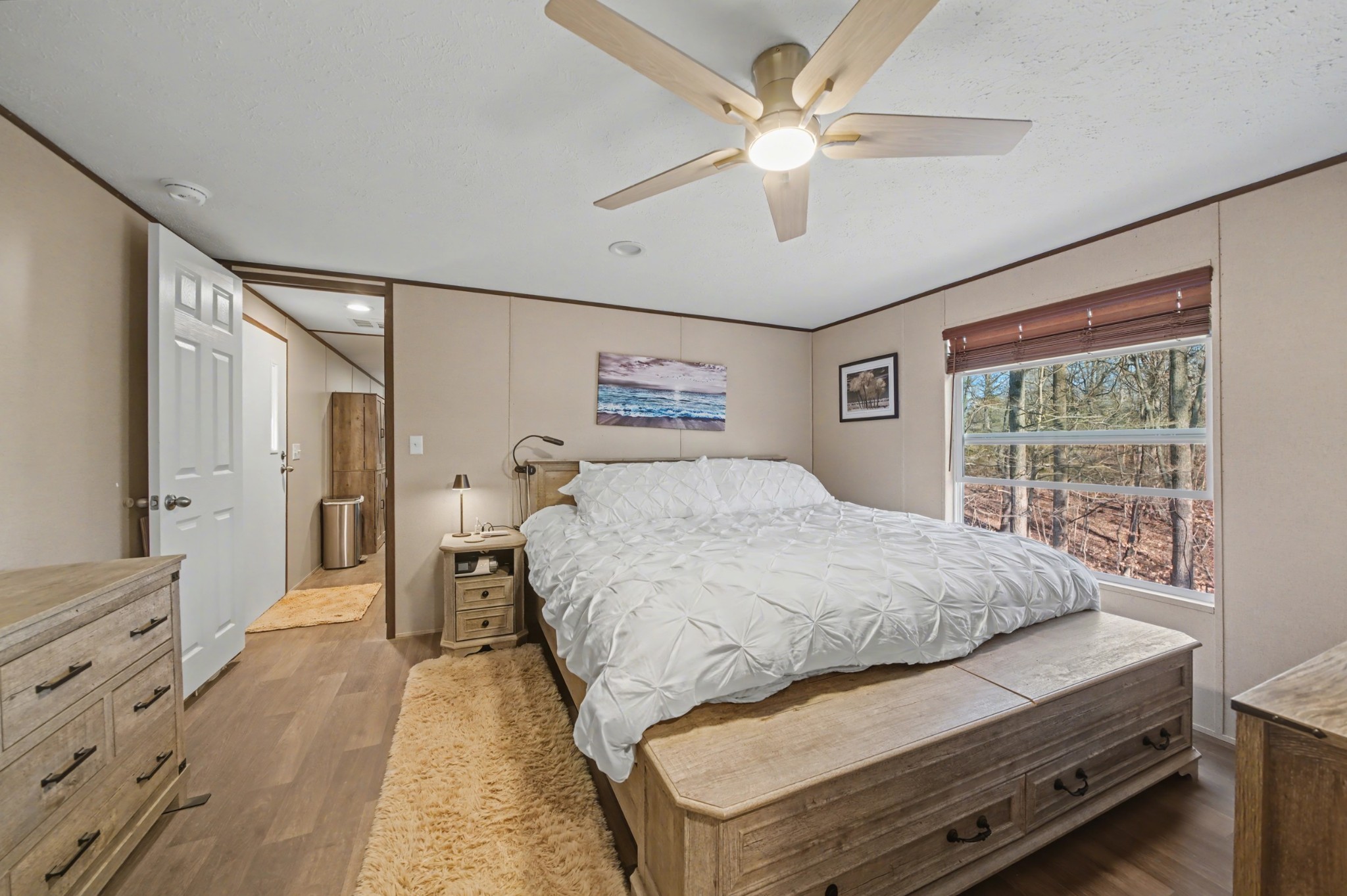 116 Lee Lane Big Rock, TN 37023 - Photo 19 of 34 a spacious bedroom with a large bed and a chandelier