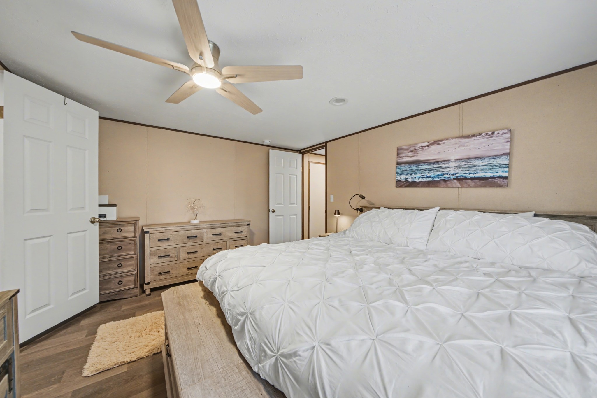 116 Lee Lane Big Rock, TN 37023 - Photo 21 of 34 a spacious bedroom with a large bed and a chandelier