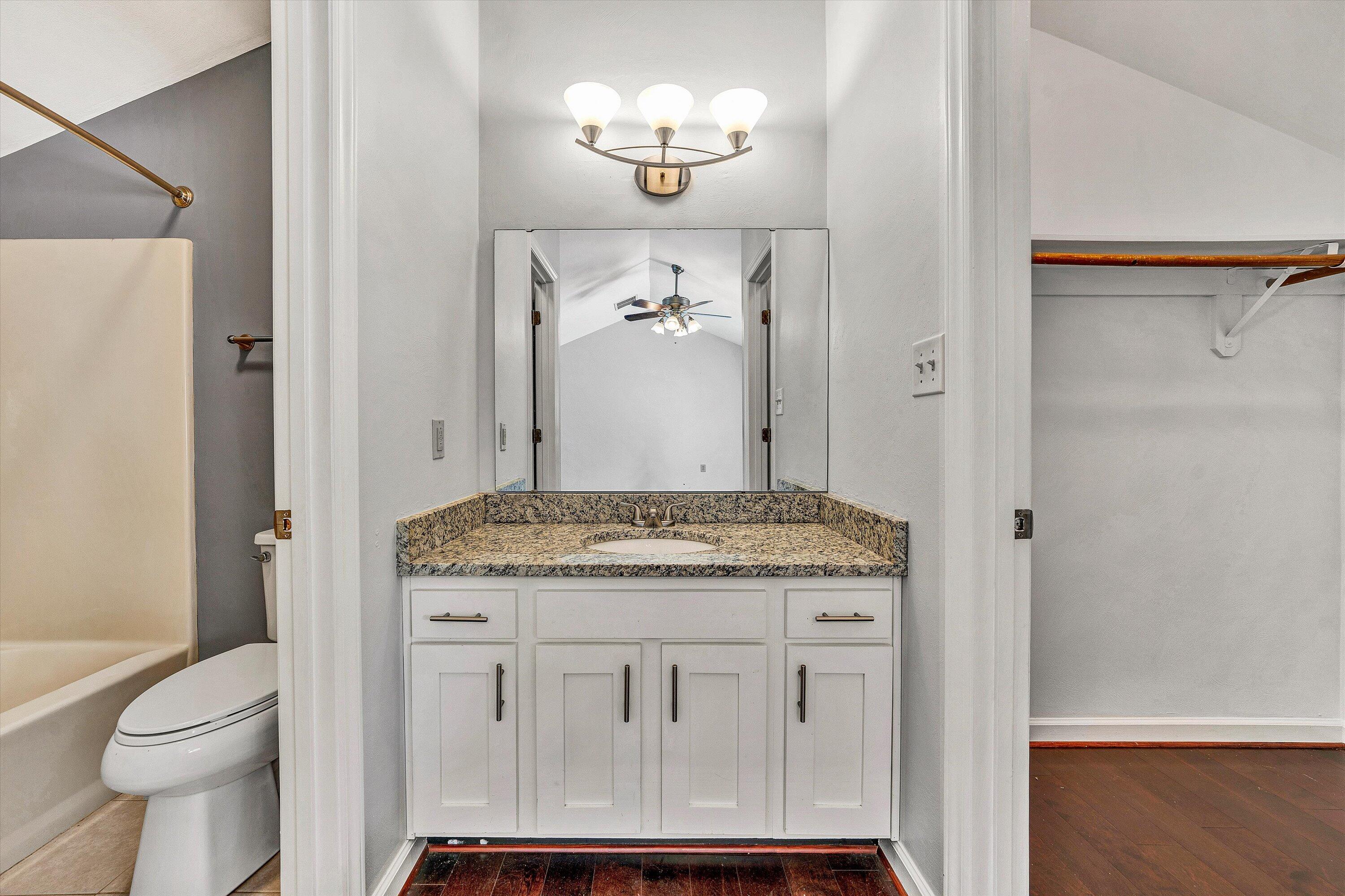 3349 Forest Ridge Road, Unit 3349 Roanoke, VA 24018 - Photo 15 of 20 a bathroom with a granite countertop sink a toilet and shower