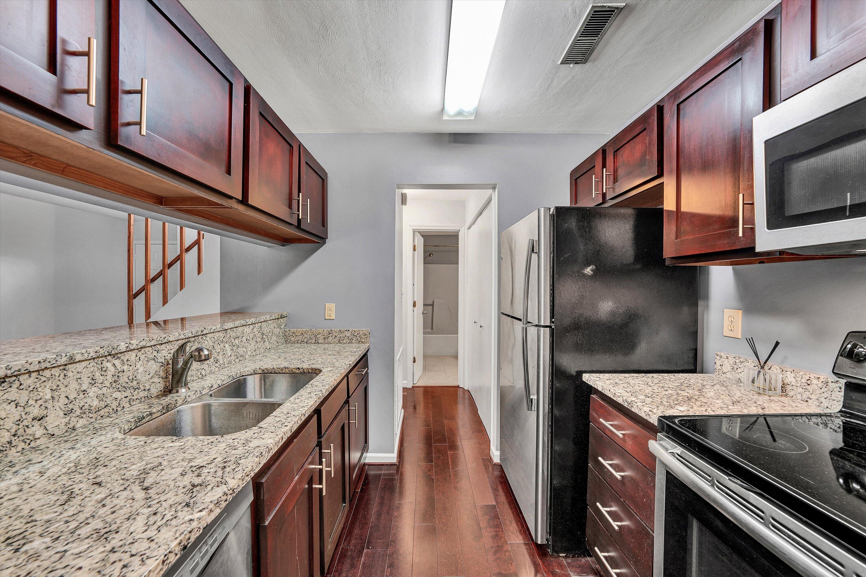 3349 Forest Ridge Road, Unit 3349 Roanoke, VA 24018 - Photo 5 of 20 a kitchen with stainless steel appliances granite countertop a sink stove and refrigerator