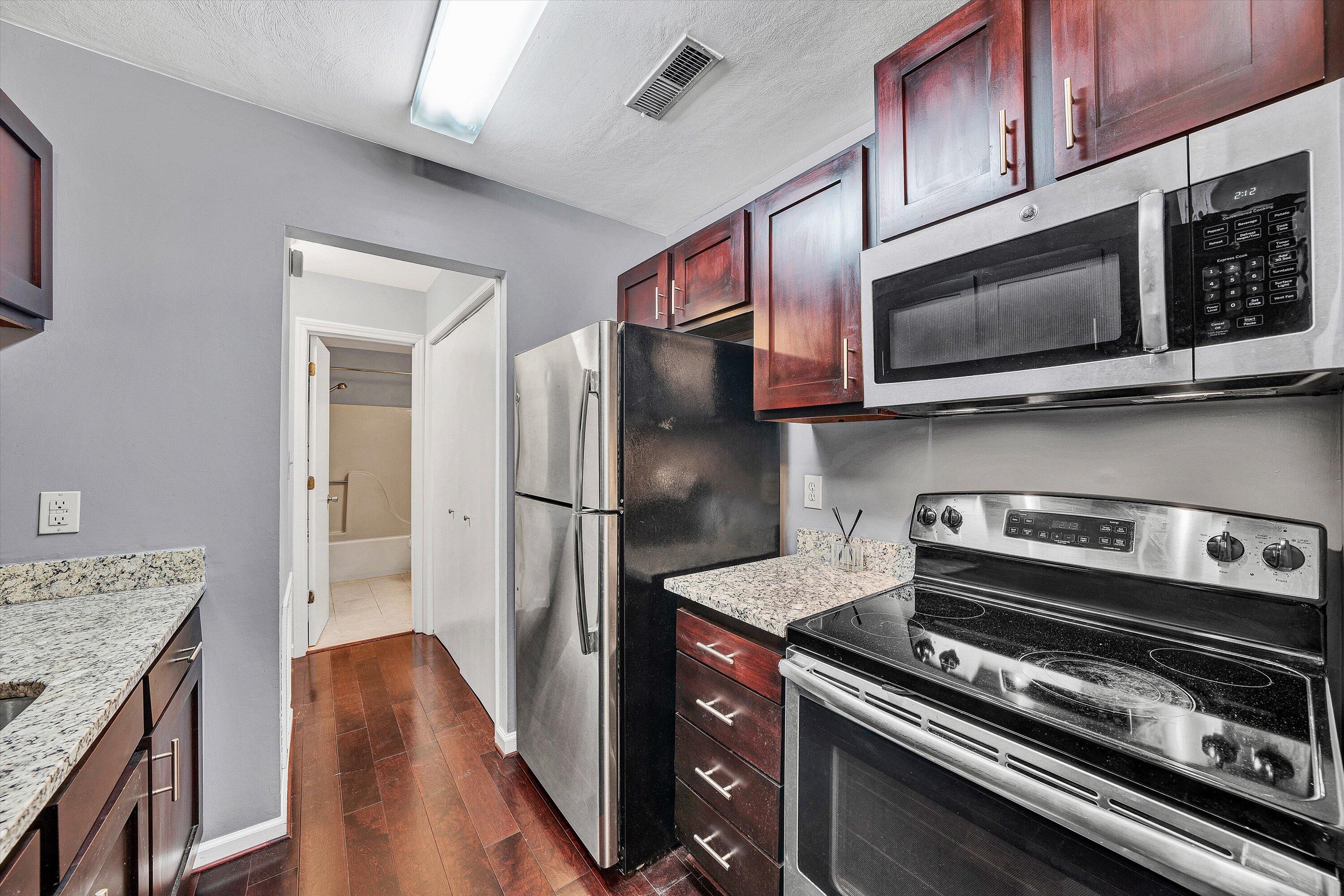 3349 Forest Ridge Road, Unit 3349 Roanoke, VA 24018 - Photo 6 of 20 a kitchen with stainless steel appliances granite countertop a stove microwave and refrigerator