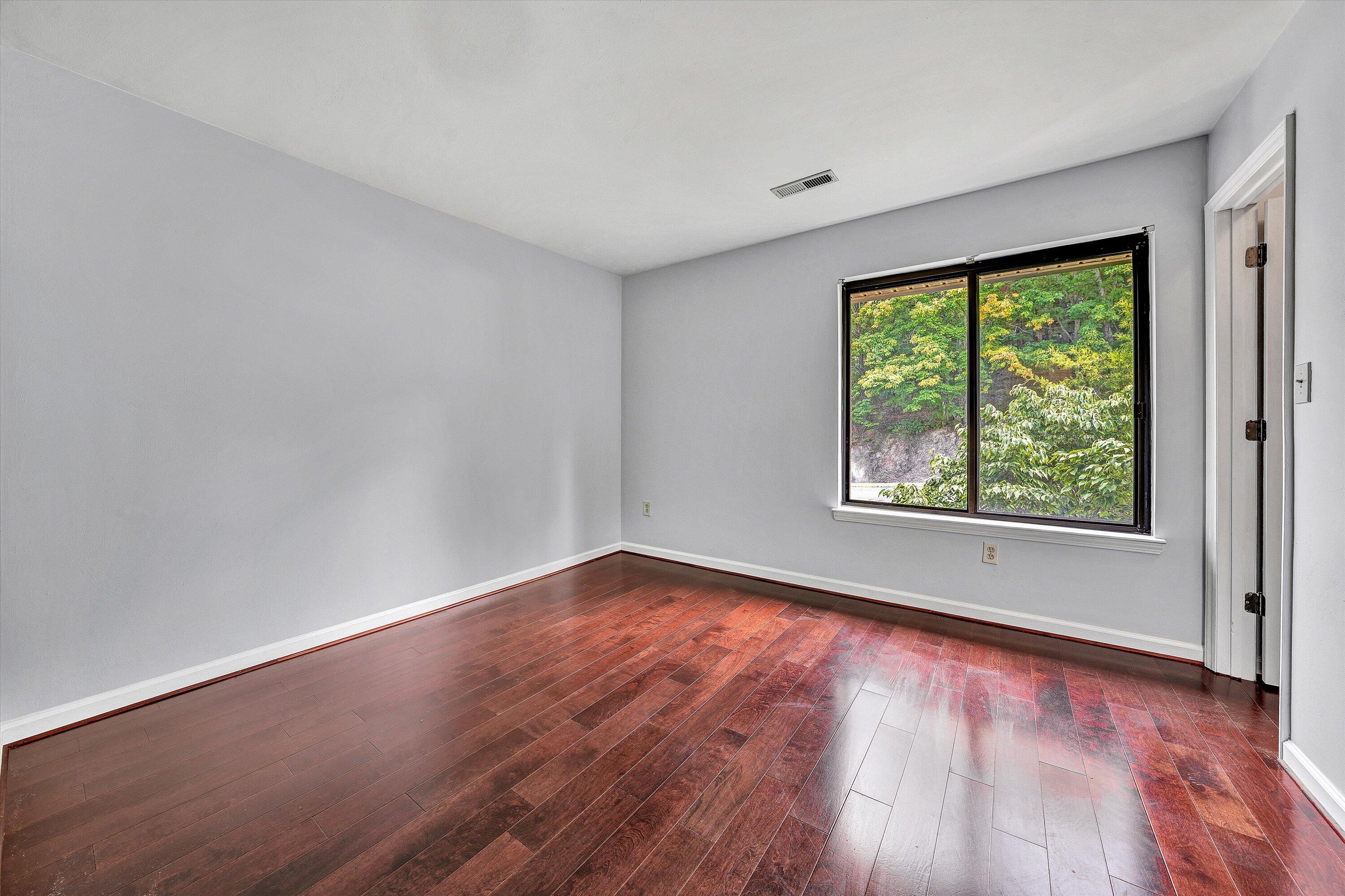 3349 Forest Ridge Road, Unit 3349 Roanoke, VA 24018 - Photo 10 of 20 a view of an empty room with wooden floor and a window