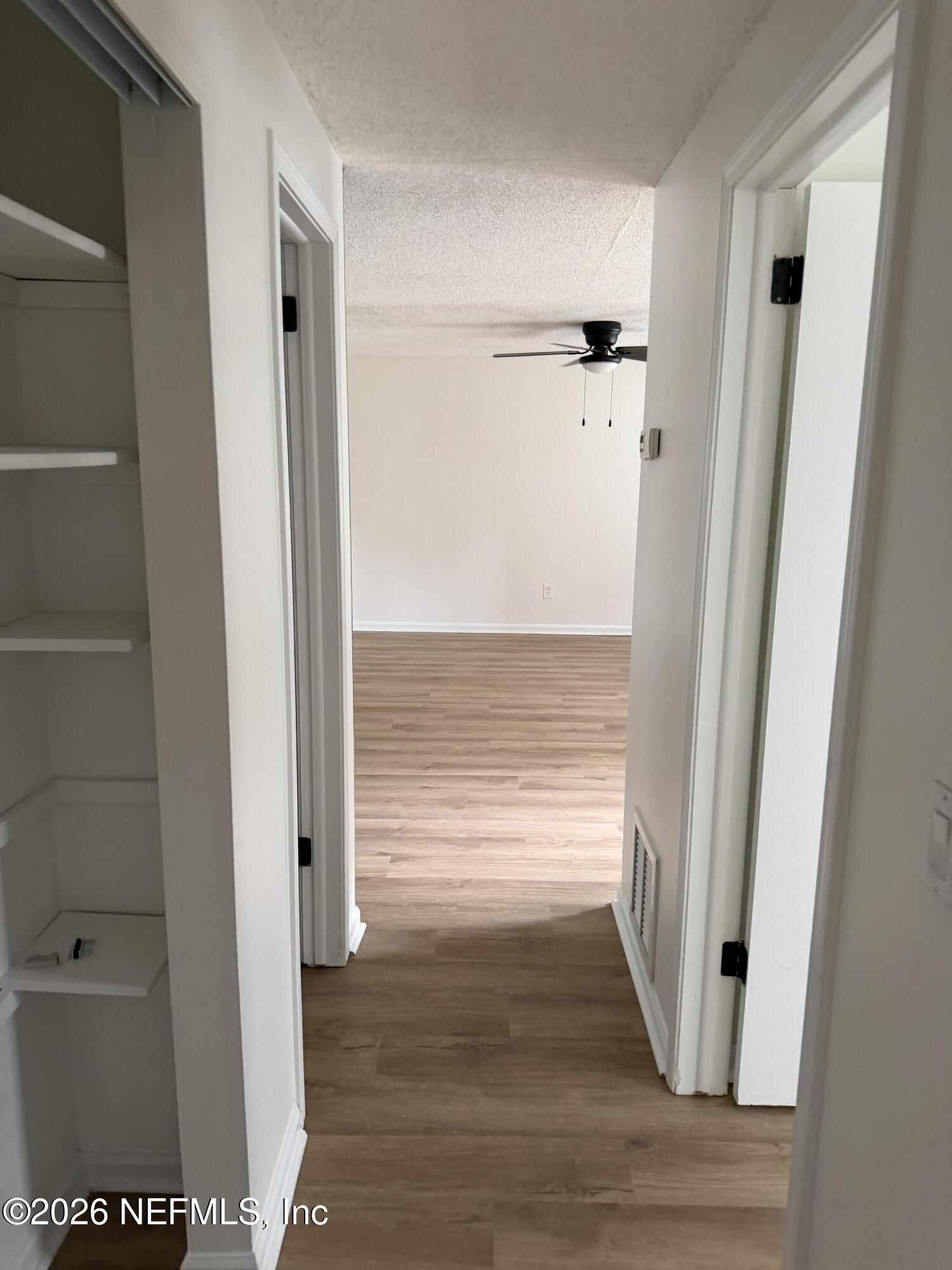 7539 Walden Road Jacksonville, FL 32244 - Photo 7 of 18 a view of walk in closet with hardwood floor and a cabinet