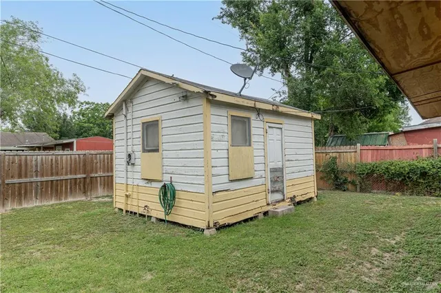 a view of backyard with small cabin