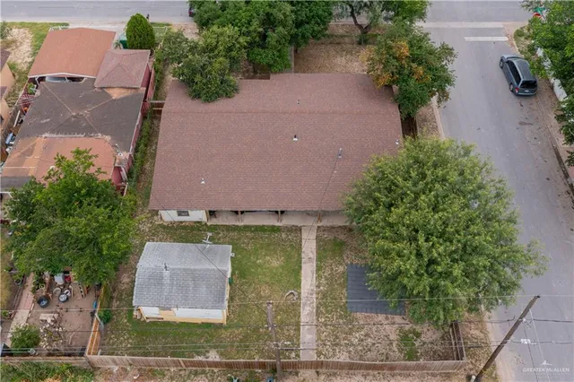 an aerial view of a house with garden space and a street view