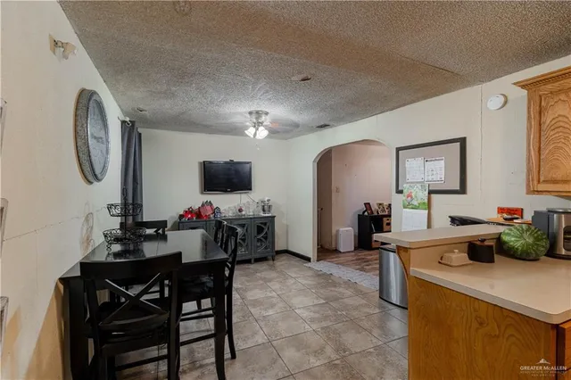 a view of a dining room with furniture and a chandelier