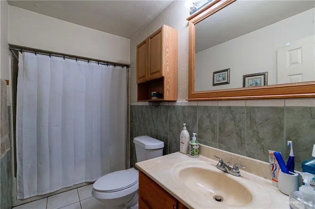 a bathroom with a sink toilet and a mirror