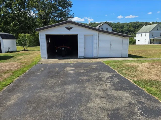 a backyard of a house with a yard and outdoor seating