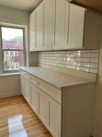 a kitchen with sink cabinets and window